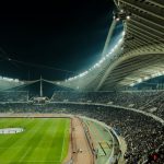 How to Watch Football Season 2026 From Anywhere: Complete Streaming Guide Football stadium illuminated at night with crowd