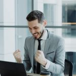 Best Coursera Courses 2026: 20+ Reviewed, Here's What's Actually Worth Your Money Person celebrating progress while learning online on a laptop — best Coursera courses 2026